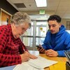 Tax Help Colorado volunteer Judy Keating helps MCC student Adrian Saldana prepare his 2022 tax return.